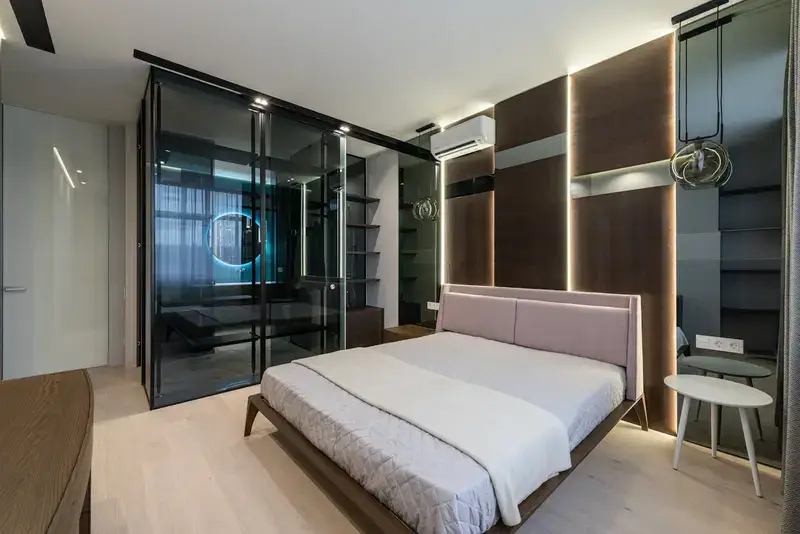 A Hotel Room, Bathroom with glass walls in modern bedroom.
